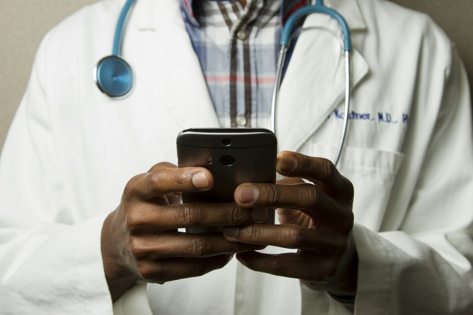 Illustrative photograph: Healthcare professional using a smartphone
